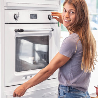 Person baking with a Smeg oven in a Noodles kitchen